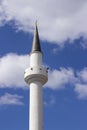 Tall white minaret of a Muslim mosque an Islamic shrine, reading the Koran through a loudspeaker on the minaret Royalty Free Stock Photo