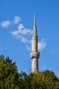 A tall white minaret of a Muslim mosque Royalty Free Stock Photo