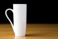 Tall white mug on a wood table