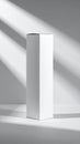 Tall White Rectangular Box Under Harsh Shadows Against a Plain White Surface with Subtle Highlights and Royalty Free Stock Photo