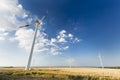 Tall Wind Turbine Overlooking Smaller Wind Turbines Royalty Free Stock Photo