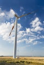 Tall Wind Turbine Overlooking Smaller Wind Turbines