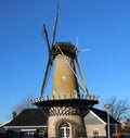 Tall windmill in krimpen aan den ijssel along river Hollandse IJssel Royalty Free Stock Photo