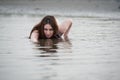 Tall woman wear bikini and pose in the sea Royalty Free Stock Photo