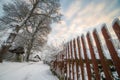 Tall wooden fence in winter