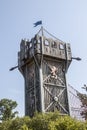 Tall wooden play climbing castle with flag and climbing bridge a Gathering Place public park in Oklahoma