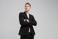 Portrait of young man in black suit with arms crossed isolated on white background Royalty Free Stock Photo