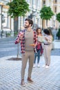 Tall young guy holding sunglasses and tablet outdoors Royalty Free Stock Photo