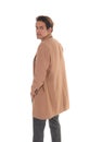 Tall young man standing in a beige coat from the back Royalty Free Stock Photo