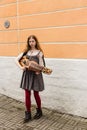 TALLIN, ESTONIA - CIRCA 2016: A female street musician plays the nyckelharpa on a side walk in the old town of Tallin in Estonia.