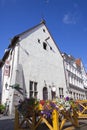 Tallinn, building of the 17th century in the old city and flags with the coats of arms of the ancient cities of the Hanseatic