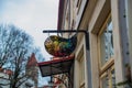 Tallinn, Estonia: The artist`s palette with paints in the form of signs. Autumn landscape. Old Fortress tower with red roof