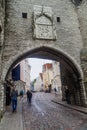 TALLINN, ESTONIA - AUGUST 22, 2016: Pikk street leading through a gate next to Fat Margaret tower in the old town of