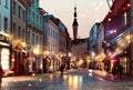 Autumn Evening in Tallinn Old Town medieval city people walk and relax night street lamp blurred on pavement travel to Estonia