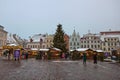 Tallinn, Estonia - Detsember 23 2020. Old Town square view with town hall and decorated fir tree shortly before