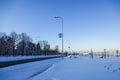 Snowy landscape by winter season at Reidi tee street promenade. Ground covered with snow. Blue clear sky. Road and bus