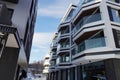 Closeup view to new modern apartments at Kalamaja. Empty bus stop on the back. Winter time with white snow. Royalty Free Stock Photo