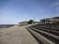 Wooden house of surfing club in Pirita on a sunny day with blue sky and wooden benches in the front.