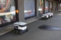 Tallinn, Estonia, Europe - September 26, 2021: Four modern automatic robot Starship for food delivery waiting on parking