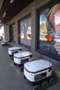 Tallinn, Estonia, Europe - September 26, 2021: Four modern automatic robot Starship for food delivery waiting on parking