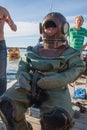 Tallinn, Estonia - July 18, 2009: A diver in a deep-sea suit sits on a chair.