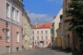 Street of Old Tallinn. Medieval houses, facades. On one house are Estonian and Finnish flags