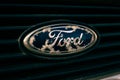 Tallinn / Estonia - Mai 1, 2021: Close up of old and damaged Ford emblem on the grill. Economy class car accessories and design