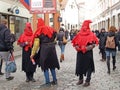 TALLINN, ESTONIA. Young men in suits of medieval executioners distribute to passersby handbills on the street of Viru Royalty Free Stock Photo