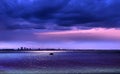 Blue pink lilac  sunset on dark sea water wave city light reflection nature landscape  seascape  skyline  On Horizon  silhouette Royalty Free Stock Photo