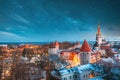 Tallinn, Estonia. Night Starry Sky Above Old Castle Walls Architecture. Cityscape Skyline In Old Town. Winter Evening