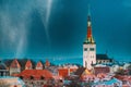 Tallinn, Estonia. Night Starry Sky Above Traditional Old Architecture Skyline In Old Town. Church Of St. Olaf Or Olav In