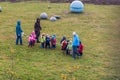 Tallinn, Estonia - October 29, 2008: Children from kindergarten walk in the park with educators and hold on to the rope.