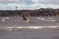 Tallinn, Estonia - October 18, 2008: Kitesurfer jumps high above the sea, doing tricks with bouncing in the windy.