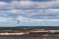 Tallinn, Estonia - October 18, 2008: Kitesurfer jumps very high above the waves with a sail, flies over the sea.