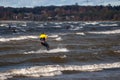 Tallinn, Estonia - October 18, 2008: Kitesurfer rides very fast through the waves with a sail.