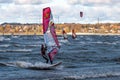 Tallinn, Estonia - October 18, 2008: A windsurfer rolls on a board with a sail in the sea in a strong wind. Royalty Free Stock Photo