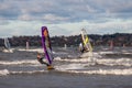 Tallinn, Estonia - October 18, 2008: Windsurfers in suits ride in the windy weather on the sea.