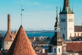 Tallinn, Estonia. Part Of Tallinn City Wall With Towers, At The Top Of Photo There Is Tower Of Church Of St. Olaf Or Royalty Free Stock Photo