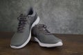 Tallinn, Estonia - 9.09.2019 : Product shoot of Nike men`s running shoe. Nike revolution 4 on brown - grey background