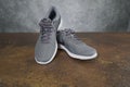 Tallinn, Estonia - 9.09.2019 : Product shoot of Nike men`s running shoe. Nike revolution 4 on brown - grey background