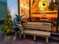 Sculpture of a bronze bull sits on a wooden bench