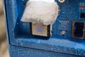 ATM under wet snow blizzard. Extreme weather in city Royalty Free Stock Photo