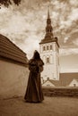 Tallinn, Estonia, sepia - Monk statue at Danish King`s Garden. The statue is made of metal and installed on the fortress wall