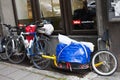 bike is tied on street with original Bicycle trailer. Bicycle bag