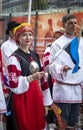 Estonian people in traditional clothing walking the streets of Tallinn