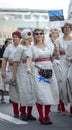 Estonian people in traditional clothing walking the streets of Tallinn