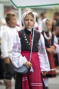 Estonian people in traditional clothing walking the streets of Tallinn