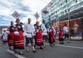 Estonian people in traditional clothing walking the streets of Tallinn