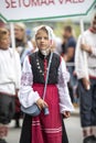 Estonian people in traditional clothing walking the streets of Tallinn