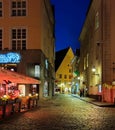 Tallinn old town hall square ,Estonia medieval city street at night restaurant people relaxing vintage candle on houses wall trave Royalty Free Stock Photo